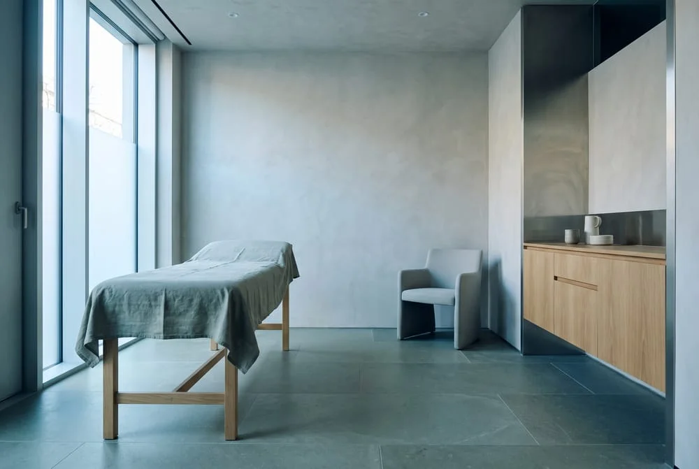 A calm, minimal orthopedic consultation room with soft daylight.