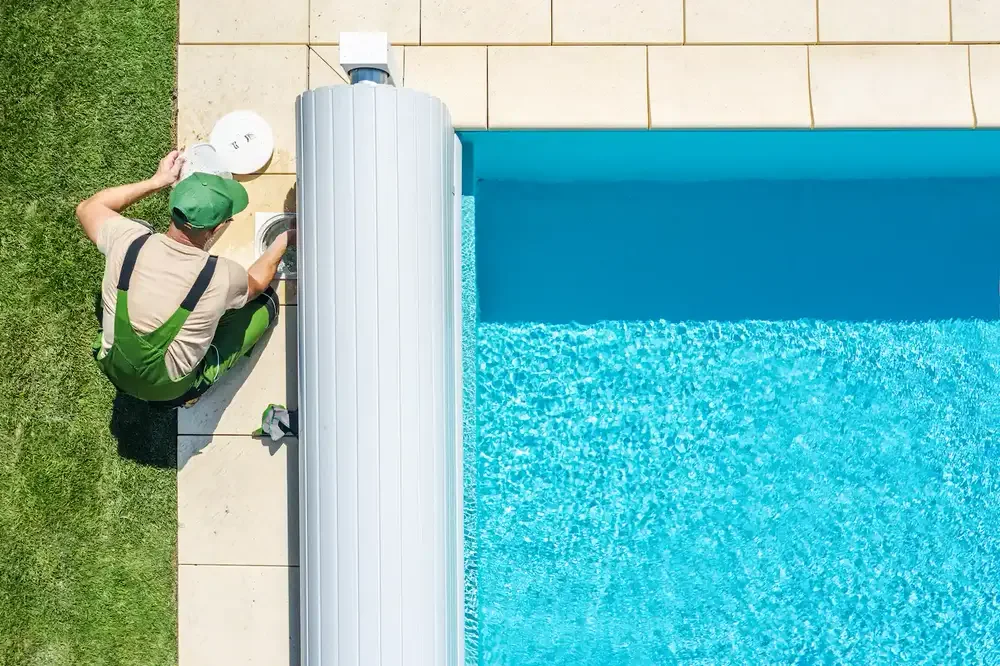 A certified TruBlu technician servicing a backyard pool