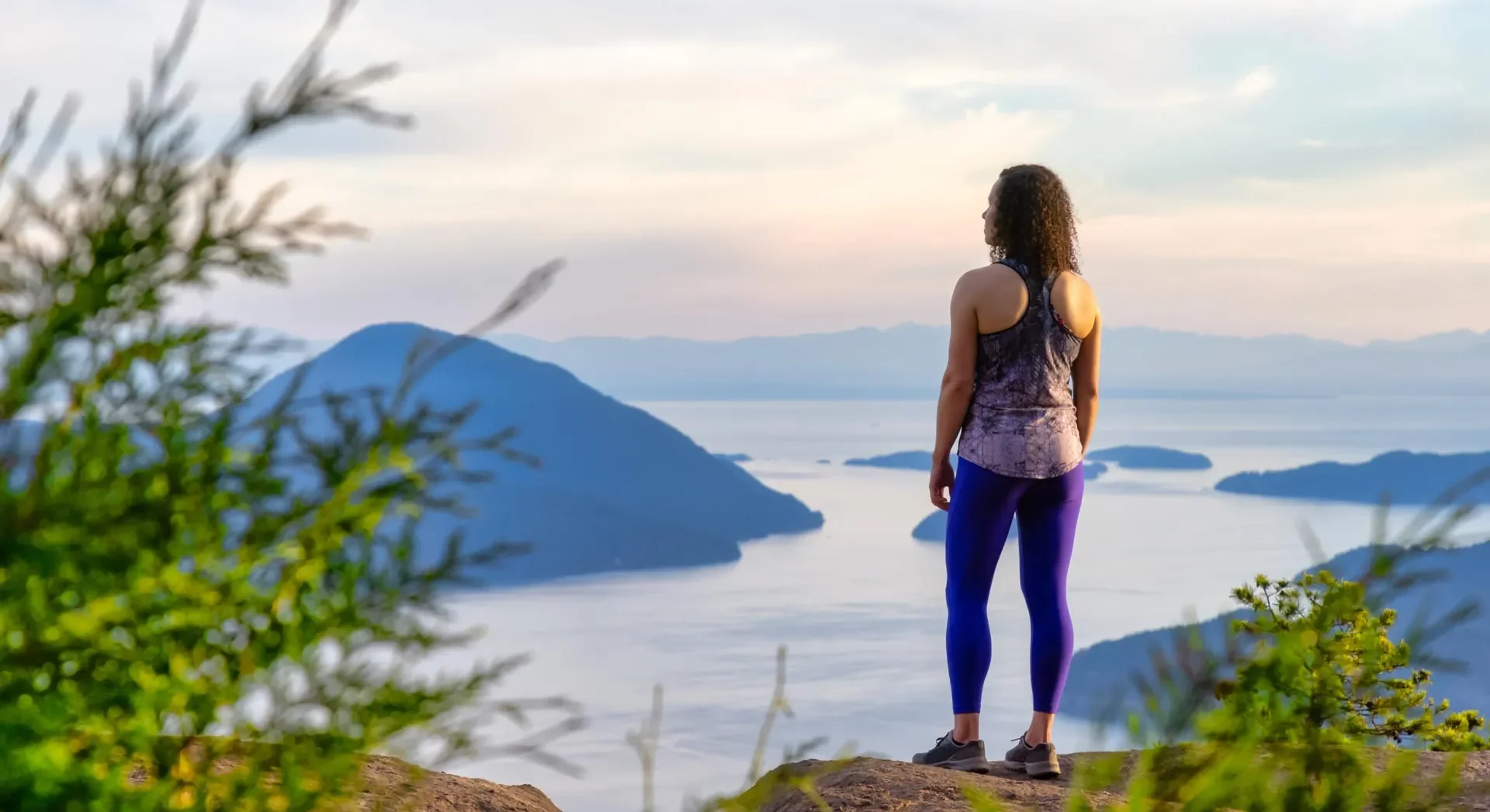 Woman hiking a Southern Utah ridgeline at golden hour