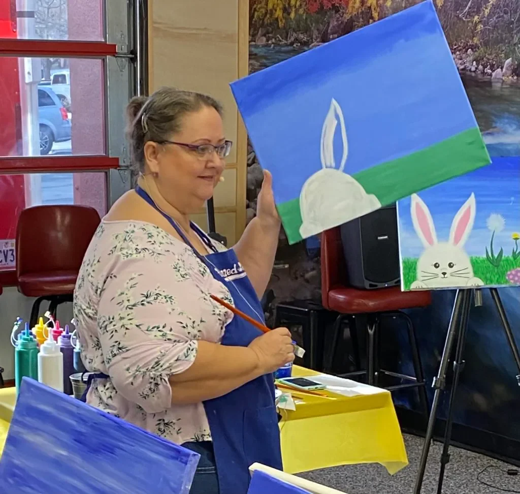 A Buzzed Arts instructor guiding painters